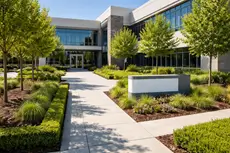 Commercial landscaping in Orangevale CA by McGuire Earth Works - professionally landscaped office building entrance with trimmed hedges and ornamental grasses